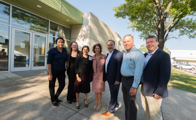 Liz Ryan, Administrator of OJJDP; Amy Solomon, Assistant Attorney General of the Office of Justice Programs; and Henry Gonzales standing with others from the Opportunity Center