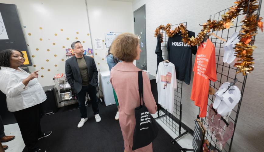 Assistant Attorney General of the Office of Justice Programs, Amy Solomon, and others looking at a display of printed items in the Opportunity Center