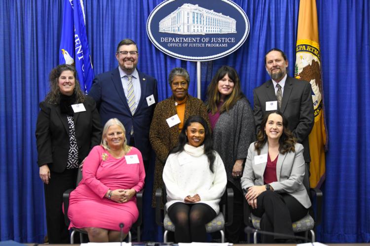 Administrator Liz Ryan and invited speakers pose for a photograph following the December 6 meeting.